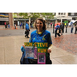 Woman holds poster for cancer patient at One Run