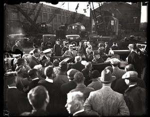 Franklin D. Roosevelt, with British Prime Minister Ramsay MacDonald, addressing a crowd gathered around his limousine while meeting the Gloucester fishermen