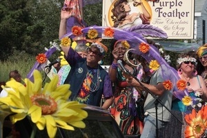 Purple Feather chocolate shop float in the parade : Provincetown Carnival parade