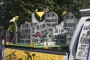 Parade float with tombstones of deceased musicians (Jerry Garcia, Liberace, Freddy Mercury, Buddy Holly) : Provincetown Carnival parade