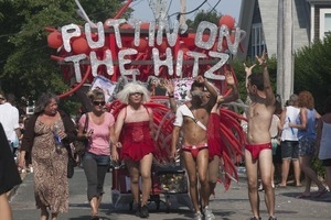 Parade marchers under the banner 'Puttin on the hitz' : Provincetown Carnival parade