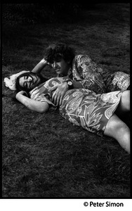Peter Simon and woman lolling on the lawn