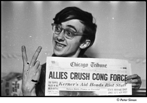 United States Student Press Association Congress: Raymond Mungo flashing peace sign and holding newspaper with headline, 'Allies Crush Cong Force' [negative damaged]