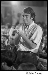 Audience member applauding at the National Student Association Congress, watching debate between Timothy Leary and Sidney Cohen on 'social philosophy'