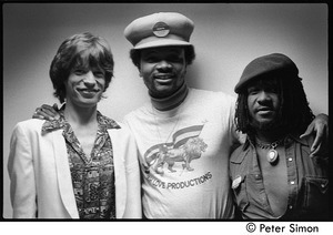 Mick Jagger, unidentified, and Sly Dunbar posed backstage, during an appearance with Peter Tosh on Saturday Night Live
