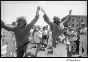 Peter Simon (left) and Bhagavan Das dancing with arms raised at Sonoma State University