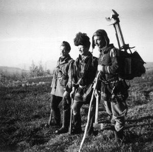 Three Sami men standing in a field near Lake Torneträsk
