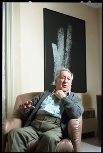 Fine art photographer Aaron Siskind: seated in a armchair in his living room