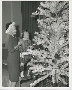 Margaret Milbank Bogert and young patient decorating Christmas tree