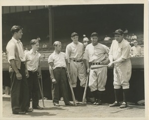 Babe Ruth posing with ICD clients at a baseball game