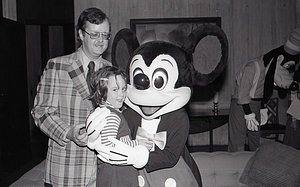 Man and Child with Disney character Mickey Mouse