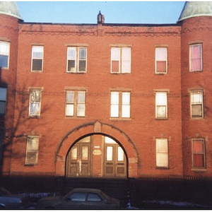 Exterior view of a brick apartment building in Roxbury, Mass
