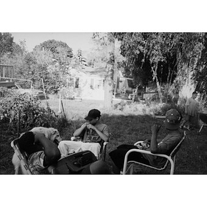 Unidentified Inquilinos Boricuas en Acción staff members sitting in a backyard at a cookout.