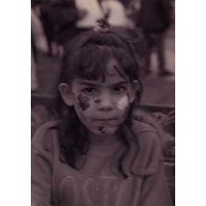 Little girl with her face painted.