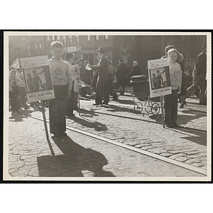 Two boys standing on a street with signs announcing the 40th anniversary of the Boys' Clubs of America and Boys' Club Week