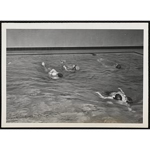 Children practice rescue techiques in a natatorium pool
