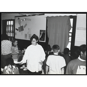 Children eat pizza at the Tri-Club slide show at the Charlestown Clubhouse