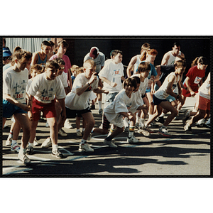 Children and teenagers leave a start line during the Battle of Bunker Hill Road Race