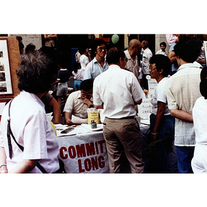 The Committee to Support Long Guang Huang distributes information at a table the August Moon Festival in Chinatown