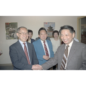 Henry Wong shakes hands with a member of the Consulate General of the People's Republic of China at a welcome party held for the Consulate General's visit to Boston