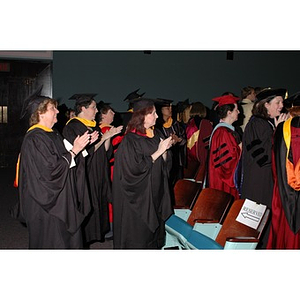 Faculty members applaud students after School of Nursing convocation