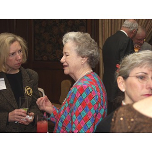 Two women talking at the gala dinner for John Hatsopoulos