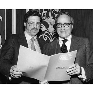 Michael Meltsner and Dean O'Toole look at a Law School brochure