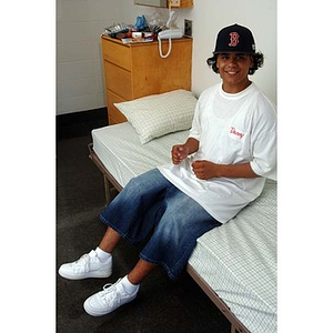 Danny Vazquez sits on his bed during move-in