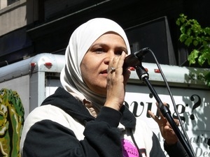 Unidentified woman in a head scarf addressing the crowd during the march opposing the War in Iraq