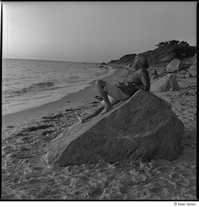 Ram Dass and Satsang: Ram Dass at the beach, reclining on a rock