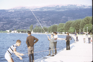 Tourists fishing on quay