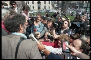 Scene outside the Hampshire County courthouse following acquittal in the CIA protest trial: Abbie Hoffman being interviewed by the press