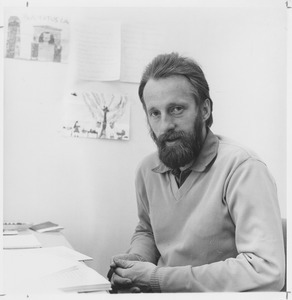 Peter Rusek seated at desk - Digital Commonwealth