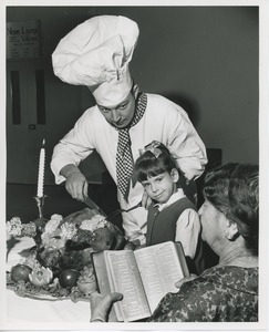 Chef carving turkey for young client