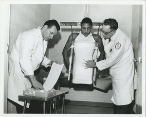 Two technicians make a plaster cast of a double amputee's body