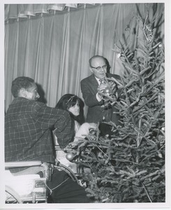 Dr. DiMichael decorating Christmas tree with clients