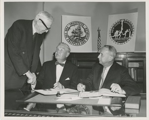 Presidents Bruce Barton of ICD and Carroll V. Newsom of NYU preparing to sign an affiliation agreement