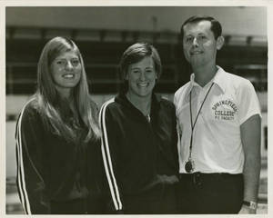 Coach Joe McEvoy standing with co-captains Ginny Ward and Sue Petersen (1974-1975)