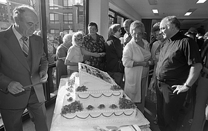 Attendees pictured with cake at dedication of Christopher Columbus Park