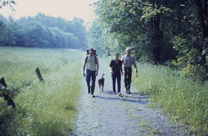 Carriage Road, Hopkins hay meadow / Meteorology field (to left). Students returning from permanent plot surveying (left to right) Martin Immerman '76, "Mocha" (HW Art's dog), Christine Henry '74, and Richard Geier '75.
