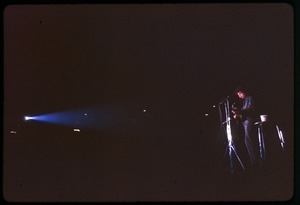 Bob Dylan performing on stage: long shot in the spotlight