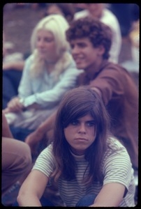 Young woman in the audience staring blankly during the Woodstock Festival