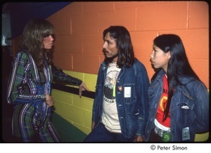 MUSE concert and rally: Carly Simon, James Trudell, and an unidentified woman backstage at the MUSE concert