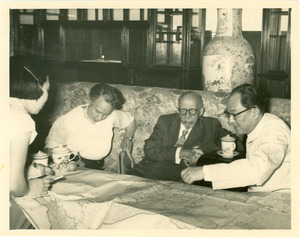 W. E. B. Du Bois, Shirley Graham Du Bois and two Chinese officials looking at map, China, 1959
