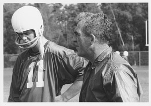 Richard Fredrick MacPherson standing with player on football field