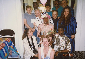 Photographs of Marsha P. Johnson Posing with Friends Holding a Flower Bouquet at Her Birthday Party