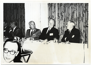 Mayor John F. Collins attending a banquet with unidentified men