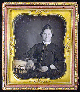 Half-length portrait of a seated adult female