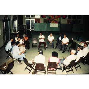 Group of adults seated in chairs arranged in a circle