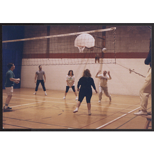Adults playing volleyball in gym at West Roxbury branch